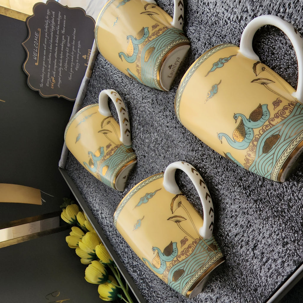 Kaunteya Airavata Premium Gift Set- Lightweight, fine bone china, tableware, luxury 4 yellow coffee mugs with a gift box, 24K gold plated, Pattachitra art, beautiful yellow and gold crockery with intricately designed green swans.