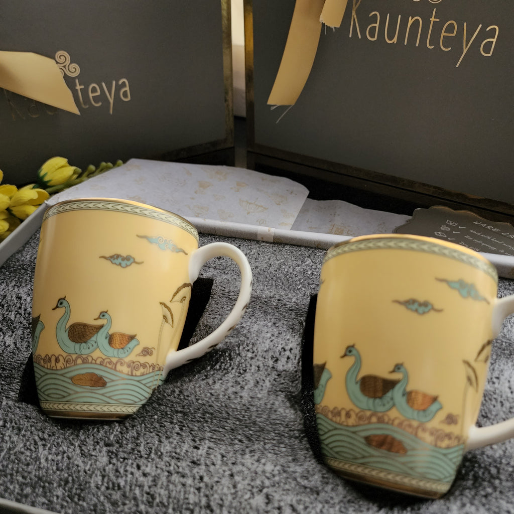 Kaunteya Airavata Premium Gift Set- Lightweight, fine bone china, tableware, luxury 2 yellow coffee mugs with a gift box, 24K gold plated, Pattachitra art, beautiful yellow and gold crockery with intricately designed green swans.